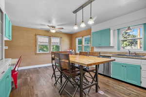 Kitchen 2 with decorative light fixtures, green cabinetry, dark wood finished floors, and dishwasher