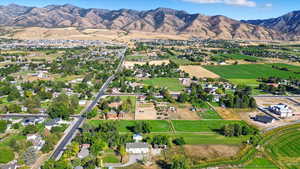 Aerial overview of property's location featuring a mountain backdrop and rural landscape