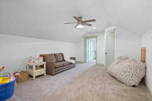 Game room with vaulted ceiling, carpet, and a ceiling fan