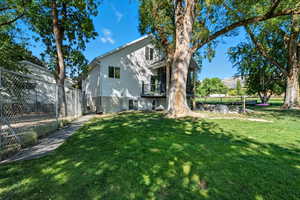 Back of property with a balcony