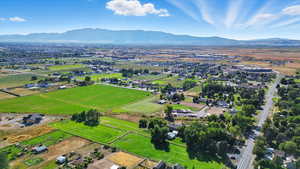 Aerial view of property and surrounding area featuring mountains and rural landscape