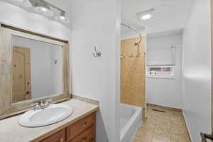 Full bathroom with vanity,  shower combination, and light tile patterned floors