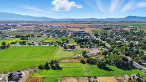 Aerial view of property's location featuring a mountainous background and rural landscape
