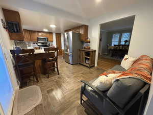 Living room featuring tile floors and ornamental molding