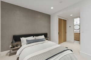 Bedroom with light carpet, recessed lighting, and ensuite bath