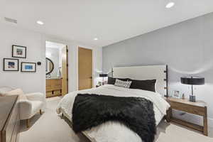 Carpeted bedroom featuring recessed lighting and ensuite bath