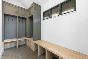 Mudroom featuring dark tile patterned floors