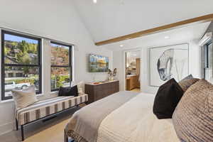 Carpeted bedroom with recessed lighting and ensuite bath