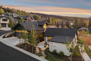 View of front of house with roof with shingles, a residential view, and driveway