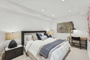 Carpeted bedroom featuring recessed lighting and baseboard heating