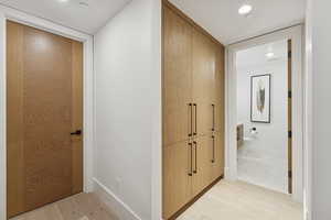 Hallway featuring parquet floors and recessed lighting