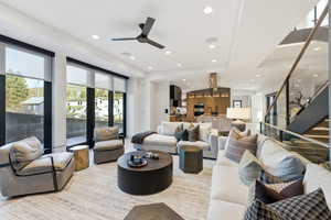 Living room with recessed lighting, stairway, a ceiling fan, and vaulted ceiling