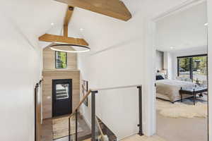 Entryway featuring beam ceiling, high vaulted ceiling, light carpet, and recessed lighting