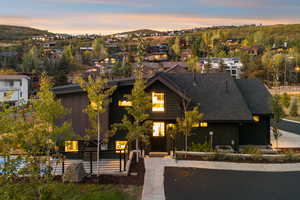 View of front of house with board and batten siding, a shingled roof, and a residential view