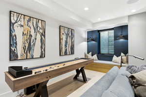 Recreation room with recessed lighting and wood finished floors