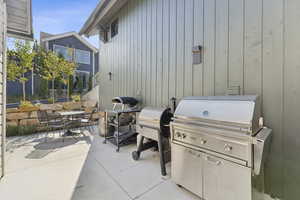 View of patio featuring area for grilling and outdoor dining space