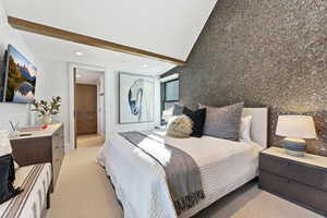 Bedroom with an accent wall, light colored carpet, recessed lighting, and beamed ceiling