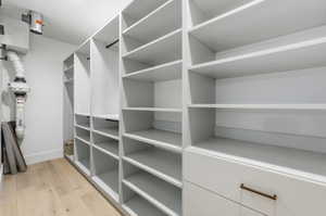Spacious closet with light wood-style flooring