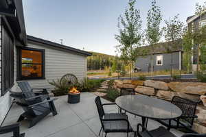 View of patio / terrace featuring outdoor dining area and a fire pit