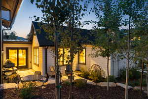 View of front of property with a standing seam roof, a metal roof, a patio area, and roof with shingles