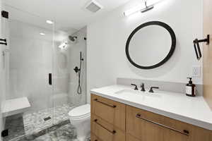 Full bathroom with a stall shower, vanity, recessed lighting, and light marble finish flooring
