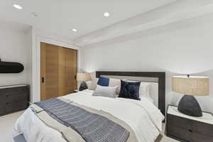 Carpeted bedroom featuring recessed lighting and a closet