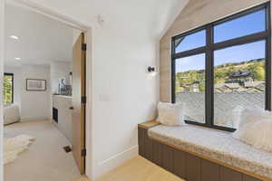 Bedroom with vaulted ceiling and light carpet