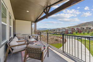 Balcony featuring a residential view, a mountain view, and outdoor lounge area