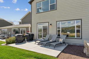 Rear view of property with a patio area and an outdoor hangout area