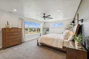 Bedroom with carpet, a ceiling fan, a textured ceiling, and recessed lighting