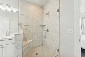 Full bathroom with a stall shower, vanity, and ensuite bath