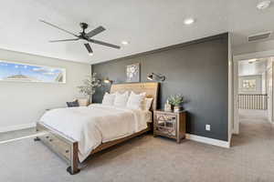 Bedroom with carpet flooring, a textured ceiling, and a ceiling fan
