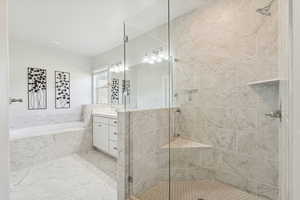 Full bath featuring vanity, a stall shower, a garden tub, and pet washing area