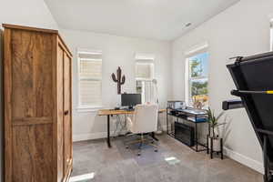 Office with light carpet and baseboards