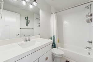 Full bathroom featuring shower / tub combo with curtain, vanity, and tile patterned flooring