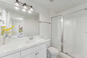Bathroom featuring vanity and a stall shower