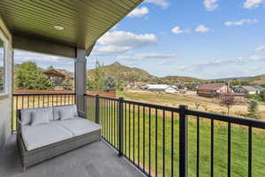 Balcony featuring a mountain view and an outdoor living space