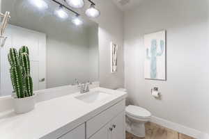 Bathroom with light wood-type flooring and vanity