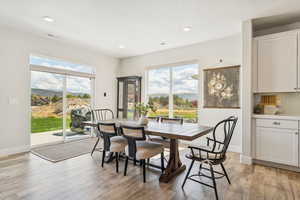 Dining area with light wood-style flooring, recessed lighting, and a textured ceiling