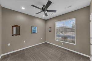 Spare room with a ceiling fan, carpet flooring, and recessed lighting