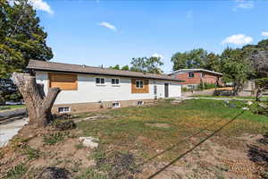 Rear view of property with brick siding and a garage