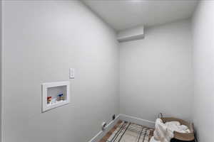 Laundry area featuring hookup for a washing machine and wood finished floors