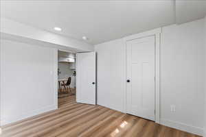 Unfurnished bedroom with light wood-style flooring and recessed lighting