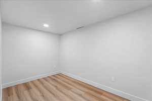 Spare room with light wood-style floors and recessed lighting
