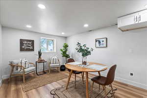 Dining area featuring light wood-style flooring and recessed lighting