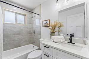Bathroom with vanity and bathing tub / shower combination