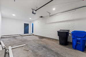 Garage featuring recessed lighting and a garage door opener