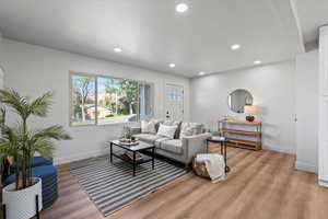 Living room with recessed lighting and light wood finished floors