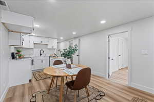 Dining room featuring light wood-style floors and recessed lighting