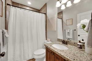 Bathroom featuring vanity and curtained shower